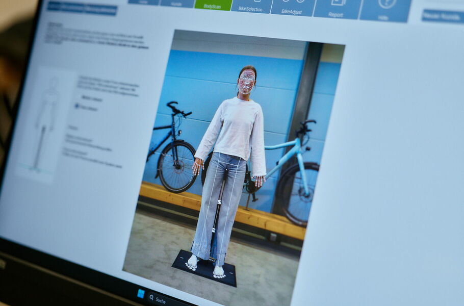 A customer is positioned on a mat, and Smartfit's camera and laser measure leg length, arm length and sternum heigh